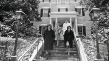 (Original Caption) Jacqueline Kennedy and her sister Lee Radziwill are shown leaving the new Georgetown home, here 12/18, which Mrs. Kennedy recently purchased. The former First Lady inspected the home just prior to departing, with her two children, for Palm Beach, Florida, where they will spend the Christmas holidays. Man in center is William Baldwin a New York City interior decorator.