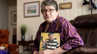 Georgene White sits for a portrait with a photo of her mother, Teri Sheridan, in Belvidere, N.J., Thursday, April 20, 2023. At age 93, struggling with the effects of a stroke, heart failure and recurrent cancer, Sheridan was ready to end her life using New Jersey’s law that allows medically assisted suicide – but she was bedbound, too sick to travel. So on Nov. 17, 2022, surrounded by three of her children, Sheridan drank a lethal dose of drugs prescribed by a doctor she had never met in person, only online. She died within minutes. (AP Photo/Matt Rourke)