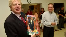 UNITED STATES - JUNE 06:  Potential Senate candidate Jerry Springer, D-Ohio, receives a doll of himself from Dustin Proehl at the Ross County Democratic Party Spring Dinner in Chillicothe, Ohio.  (Photo By Tom Williams/Roll Call/Getty Images)