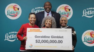 Geraldine Gimblet, bottom center, won $2 million in the Florida Lottery after spending her life savings to pay for her daughter’s cancer treatment.