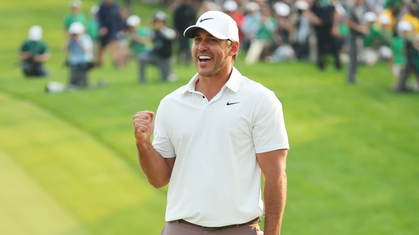 Brooks Koepka of the United States celebrates winning on the 18th green during the final round of the 2023 PGA Championship at Oak Hill Country Club on May 21, 2023 in Rochester, N.Y.