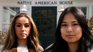 Dartmouth College students Ahnili Johnson-Jennings and Marisa Joseph, right, seen outside the college's Native American House, April 7, 2023, in Hanover, New Hampshire.