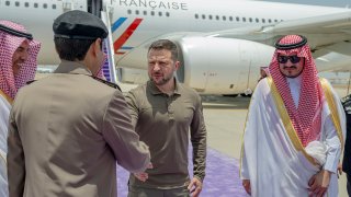 In this photo provided by Saudi Press Agency, SPA, Ukraine’s President Volodymyr Zelenskyy, second right, is greeted by Prince Badr Bin Sultan, deputy governor of Mecca, right, upon his arrival at Jeddah airport, Saudi Arabia, Friday, May 19, 2023.