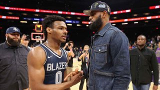 PHOENIX, ARIZONA – DECEMBER 11: Bronny James #0 of the Sierra Canyon Trailblazers is greeted by his father and NBA player LeBron James after defeating the the Perry Pumas in the Hoophall West tournament at Footprint Center on December 11, 2021 in Phoenix, Arizona. (Photo by Christian Petersen/Getty Images)