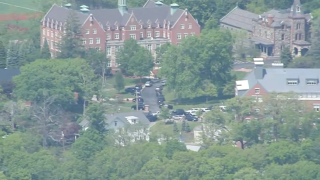 Vehicles outside St. John's Prep in Danvers, Massachusetts, on Monday, May 22, 2023, when an active shooter threat was reported, bringing out a heavy police response.