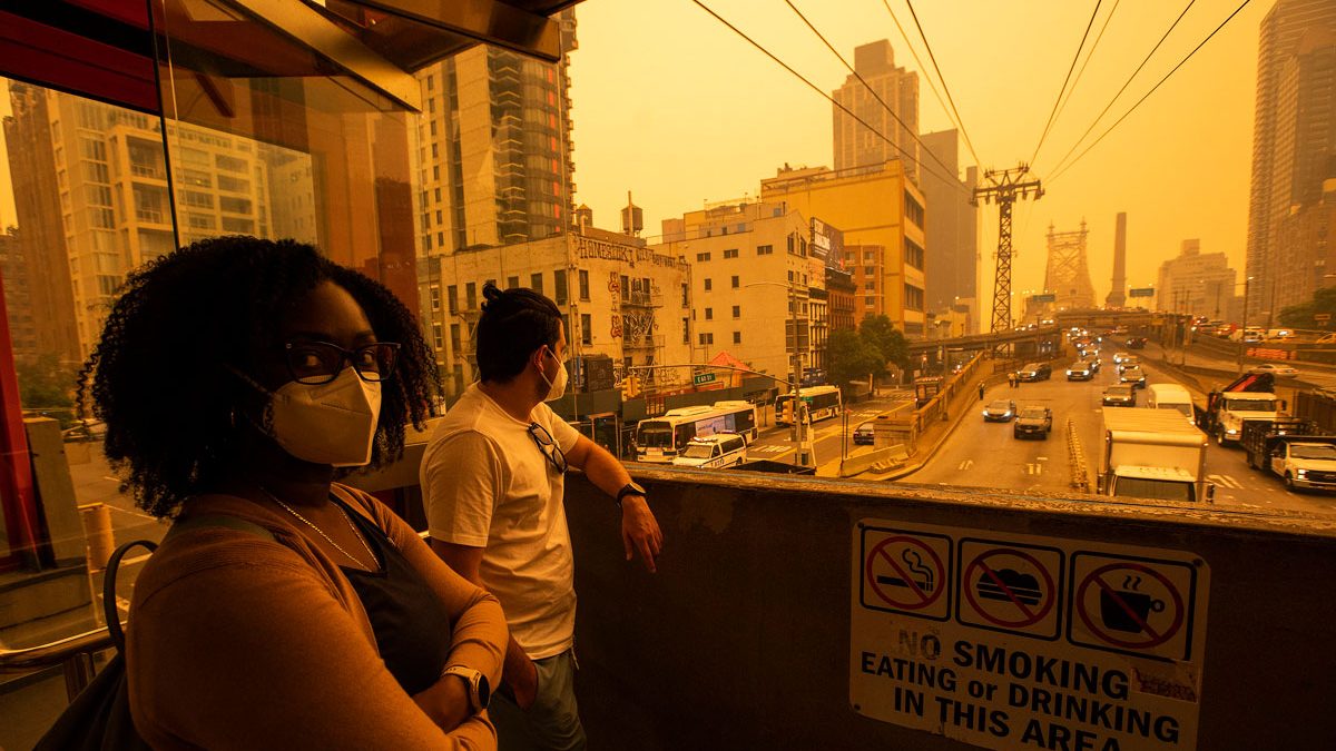 Living in sepia: Photos from NYC show thick wildfire smoke creating orange glow