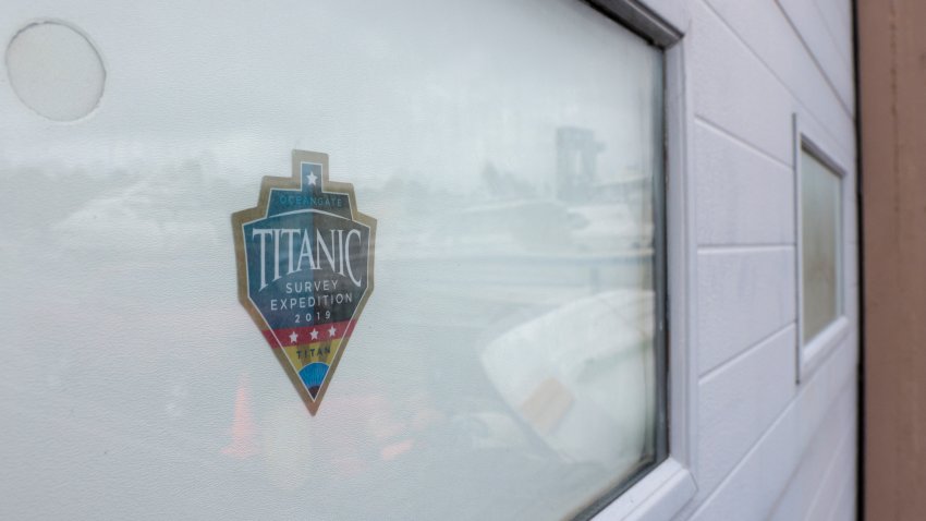 A decal which reads “Titanic Survey Expedition 2019 Titan” is pictured on a window at OceanGate at the Port of Everett Boat Yard in Everett, Washington, on June 20, 2023. Deep-sea thrill-seeker Stockton Rush founded OceanGate in 2009 with the hopes of advancing submersible vehicle technology and taking travelers into the darkest depths of the ocean. During such a mission on June 18, 2023, the submersible — with Rush onboard — went missing, losing contact with the surface ship less than two hours after it began its descent. An international search effort was launched to try and find Rush and the four other passengers in the remote North Atlantic, but no sign of them has been found. (Photo by Jason Redmond / AFP) (Photo by JASON REDMOND/AFP via Getty Images)