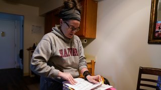 Samantha Richards looks over her Medicaid papers, June 9, 2023, in Bloomington, Ind.