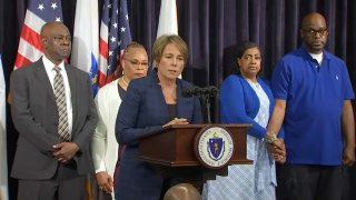 Massachusetts Gov. Maura Healey announcing that she is recommending seven people for pardons, including Glendon King (far left) and Terrance Williams (far right).