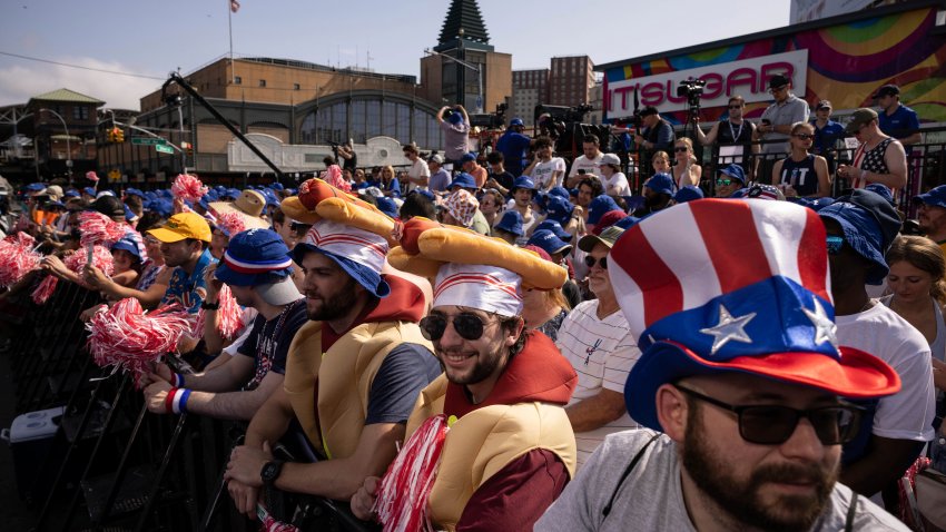 People gather ahead of the 2023 Nathan’s Famous Fourth of July hot dog eating contest in the Coney Island section of the Brooklyn borough of New York, Tuesday, July. 4, 2023.