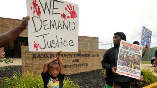 FILE – An anti-police brutality activist looks back at the entrance to the Rankin County Sheriff’s Office in Brandon, Miss., Wednesday, July 5, 2023, as the group called for the termination and prosecution of Rankin County Sheriff Bryan Bailey for running a law enforcement department that allegedly terrorizes and brutalizes minorities.