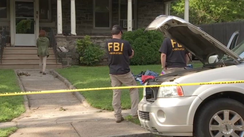 Federal agents outside a home in West Philadelphia after a teen was arrested in an ongoing terrorism investigation.