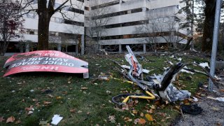 This Nov. 20, 2022, photo shows debris at the scene of a Brandeis University shuttle bus crash on South Street that left one person dead and 27 injured.