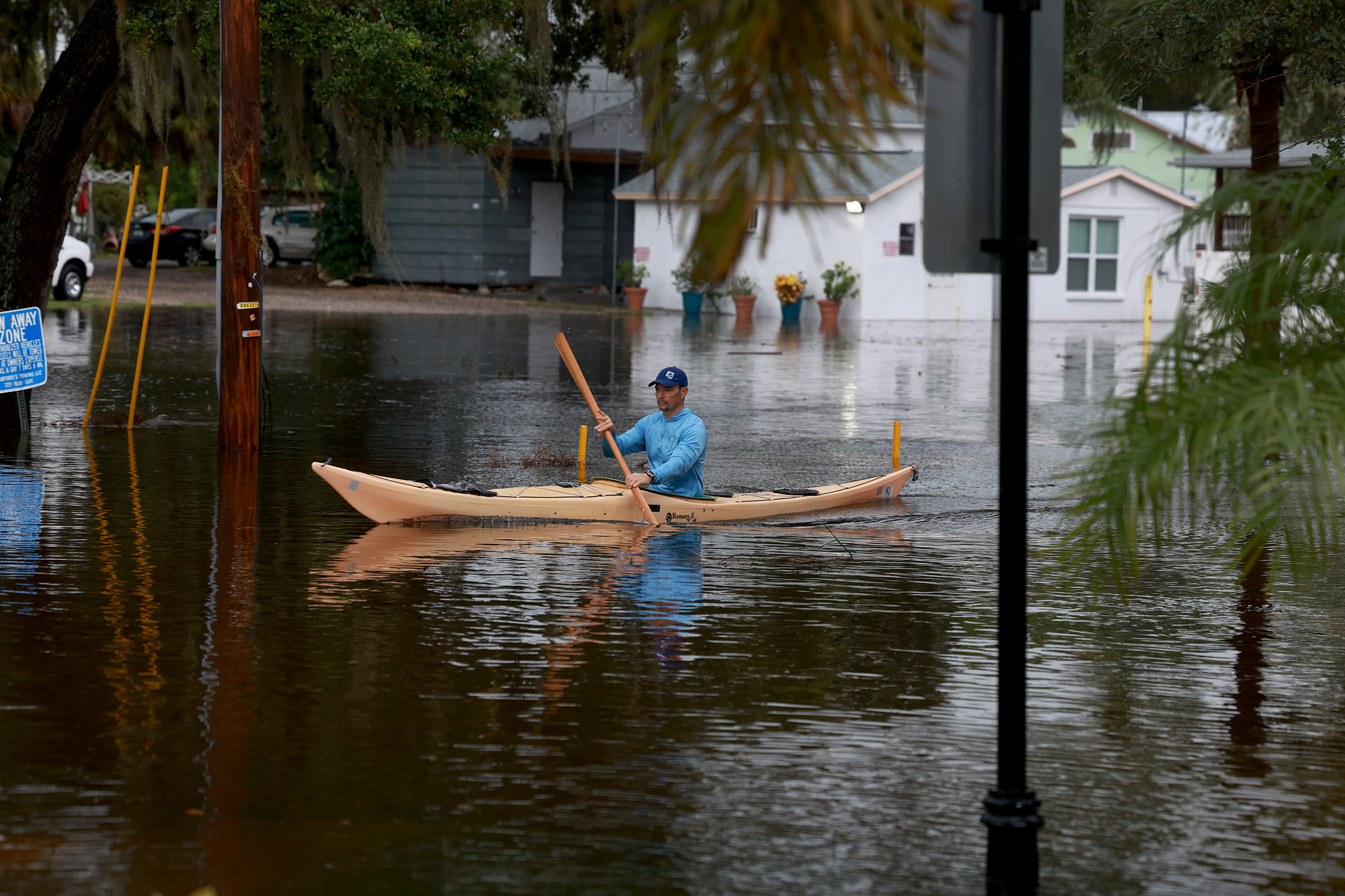 A person rides a kayak through flooded streets as Hurricane Idalia passes offshore, Aug. 30, 2023 in Tarpon Springs, Florida.