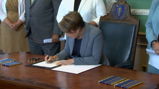 Massachusetts Gov. Maura Healey signs the 2024 budget on Wednesday, Aug. 9, 2023.