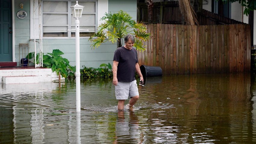 Don Hawthorne walks across his flooded yard in unincorporated Pinellas County, Fla., after the storm surge from Hurricane Idalia moved by the area, Aug. 30, 2023. The National Oceanic and Atmospheric Administration announced Monday, Sept. 11, that there have been 23 weather extreme events in America that cost at least $1 billion this year through August, eclipsing the year-long record total of 22 set in 2020.