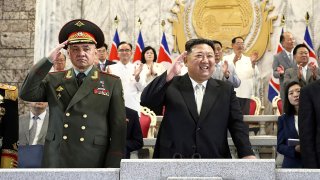 In this photo provided by the North Korean government, North Korean leader Kim Jong Un, center, Russian Defense Minister Sergei Shoigu, left,