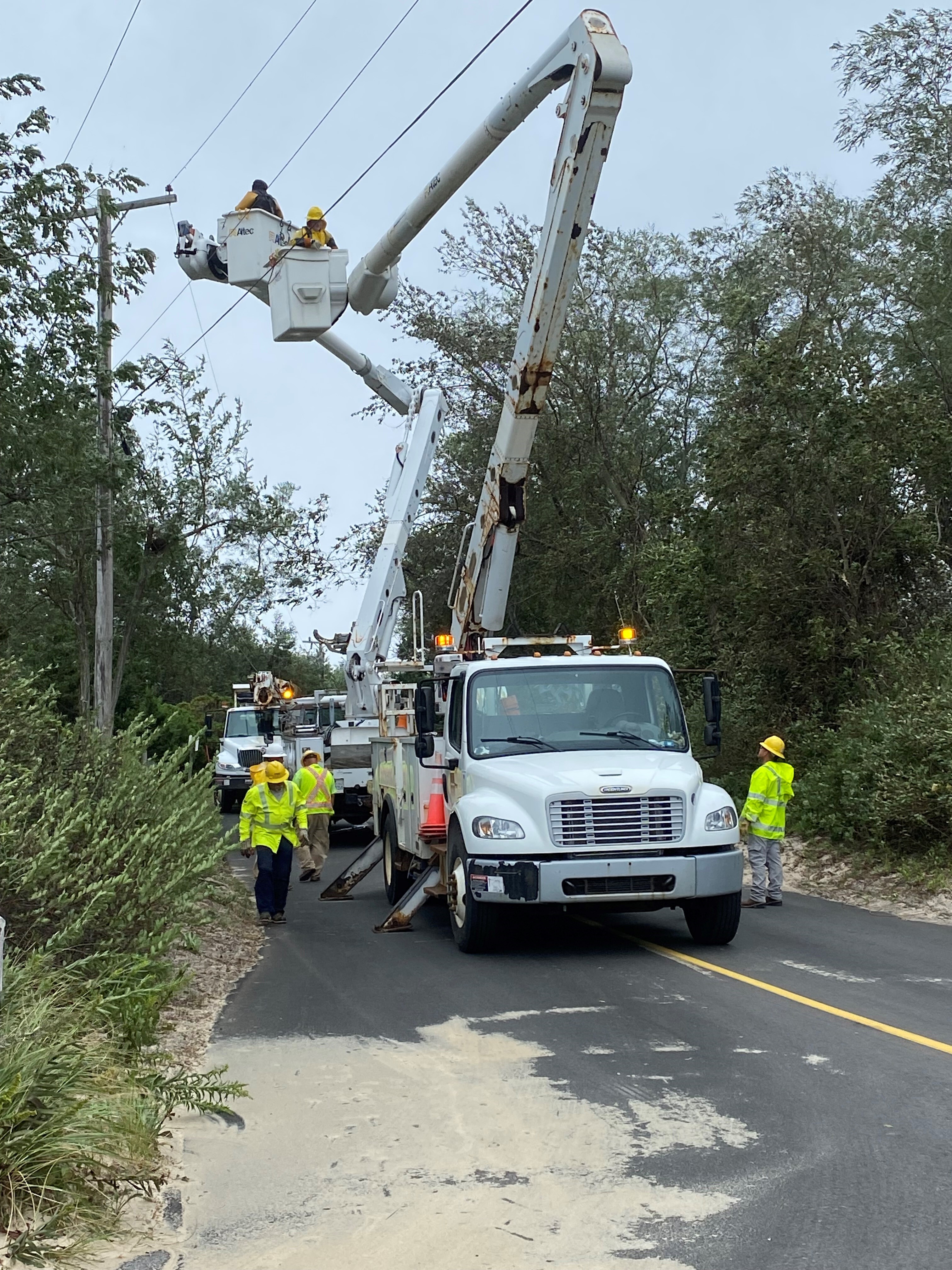 Power crews work to repair damaged and fallen power lines after Post-Tropical Cyclone Lee on Sept. 16, 2023, in Brewster, Mass. Formerly a hurricane, the storm was downgraded, but forecasters say it will remain large and dangerous.