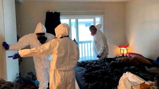 FILE - In this photo released by the Santa Rosa Police Department, investigators collect evidence from the home of Evan Frostick and Madison Bernard, the parents of a 15-month-old toddler found unresponsive in a bedroom in Santa Rosa, Calif., on May 9, 2022.