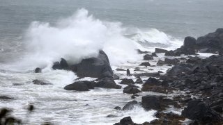 Waves crash onto the shore of Maine