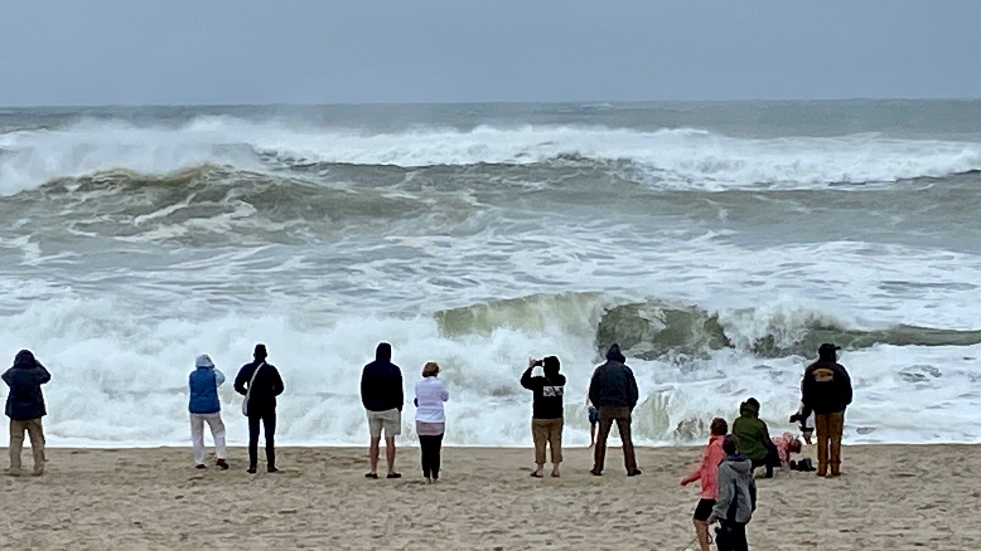 Spectators watch as large waves hit Nauset Beach in Eastham, Mass., on Sept. 16, 2023, following Post-Tropical Cyclone Lee. Formerly a hurricane, the storm was downgraded, but forecasters say it will remain large and dangerous.