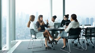 Group of businesswomen having meeting in boardroom