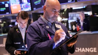 Traders work on the floor of the New York Stock Exchange during morning trading on October 04, 2023 in New York City. 