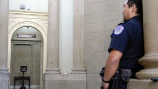 U.S. Capitol Police officer stands guard outside the office of the Speaker of the House