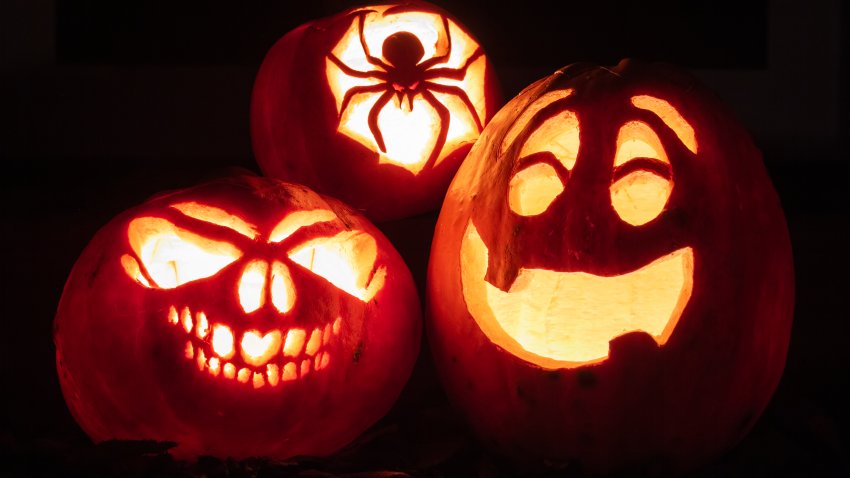 Night shot of illuminated pumpkins in front of a house