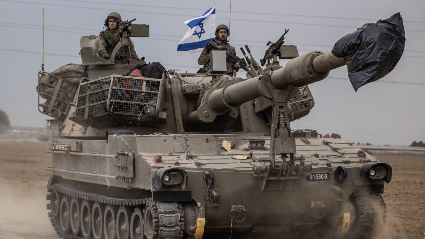 Israeli soldiers on a tank move near Gaza border as Israeli army deploys military vehicles around the Gaza Strip in Sderot, Israel on October 09, 2023.