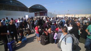 FILE - People wait for the opening of the Rafah border crossing in the southern Gaza Strip city of Rafah, on Oct. 16, 2023.