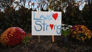 A "Lewiston Strong" is left by flowers in Lewiston, Maine, on October 27, 2023