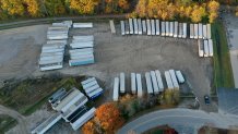 LISBON, MAINE - OCTOBER 28:  In an aerial view, police vehicles are seen in the area near the Maine Recycling Center building where Robert Card, the suspect in two mass killings, was found dead on October 28, 2023 in Lisbon, Maine. Mr. Card, who had worked at the recycling center, allegedly killed 18 people in a mass shooting at a bowling alley and restaurant in Lewiston.  (Photo by Joe Raedle/Getty Images)