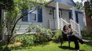 Julie McMurtry joins a zoom call with co-workers from her home in Arlington, Virginia, on May 25, 2023. The pandemic forced Americans to work from home. And now, more than three years on, employers are struggling to bring them back to the office.