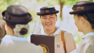 A Norland trainee nanny in formal uniform. Graduates are not expected to wear their uniform once they start working for a family, unless requested for a special occasion.