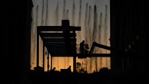 Construction workers build a grandstand in front of the fountains at Bellagio hotel-casino along the Las Vegas Strip ahead of the Las Vegas Formula One Grand Prix auto race Tuesday, Sept. 19, 2023, in Las Vegas. (AP Photo/John Locher)