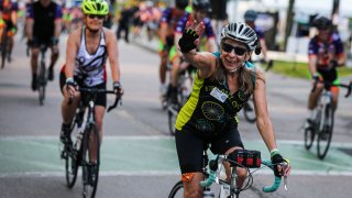 Wellesley, MA – August 7: Martha Gold waves to onlookers as she begins the Pan-Mass Challenge (PMC) from Babson College in Wellesley, MA on Aug. 7, 2021. Pan-Mass Challenge (PMC) is a two-day, 211-mile bike- a-thon that brings together more than 6,000 riders to cycle across Massachusetts and raises more money for charity than any other single athletic fundraiser. (Photo by Erin Clark/The Boston Globe via Getty Images)