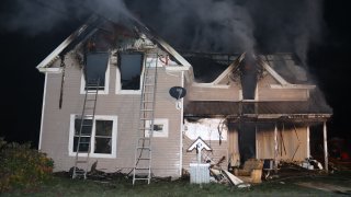 A burning house in which three family members were found dead in Fort Fairfield, Maine, early Thursday, Nov. 2, 2023.