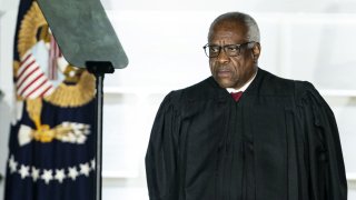 Clarence Thomas, associate justice of the U.S. Supreme Court, listens during a ceremony on the South Lawn of the White House in Washington, D.C., U.S., on Monday, Oct. 26, 2020.