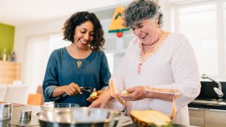 Mother and Daughter Preparing the Christmas Meal in the Kitchen