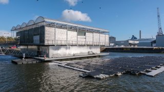 Solar panels sit outside the Floating Farm on Nov. 7 2023