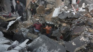 Palestinians look for survivors of the Israeli bombardment of the Gaza Strip