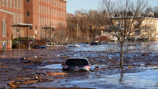 Cars are flooded in a parking lot.