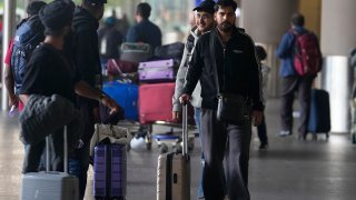 Indian passengers who travelled in an unmarked Legend Airlines A340 from Vatry Airport in France, arrive at the Chhatrapati Shivaji Maharaj International Airport in Mumbai, India, Tuesday, Dec. 26, 2023.