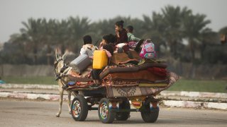 Palestinians flee the Israeli ground offensive in Khan Younis, Gaza Strip, Dec. 27, 2023.