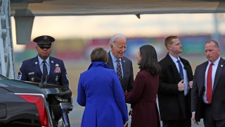 Boston, MA - December 5: President Joe Biden, Massachusetts Governor Maura Healey and Boston Mayor Michelle Wu share a moment together as the president arrives at Logan Airport.
