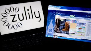 The Zulily Inc. website and logo are displayed on laptop computers arranged for a photograph