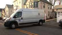 A Massachusetts medical examiner vehicle at the scene of an investigation in Lawrence, Massachusetts, on Tuesday, Dec. 26, 2023.