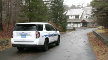 Police at the scene of a house in Dover, Massachusetts, on Friday, Dec. 29, 2023, where three family members were found dead the day before.