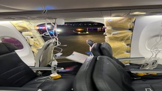 Passenger oxygen masks hang from the roof next to a missing window and a portion of a side wall of an Alaska Airlines Flight 1282, which had been bound for Ontario, California and suffered depressurization soon after departing, in Portland, Oregon, U.S., on Jan. 5, 2024, in this picture obtained from social media.